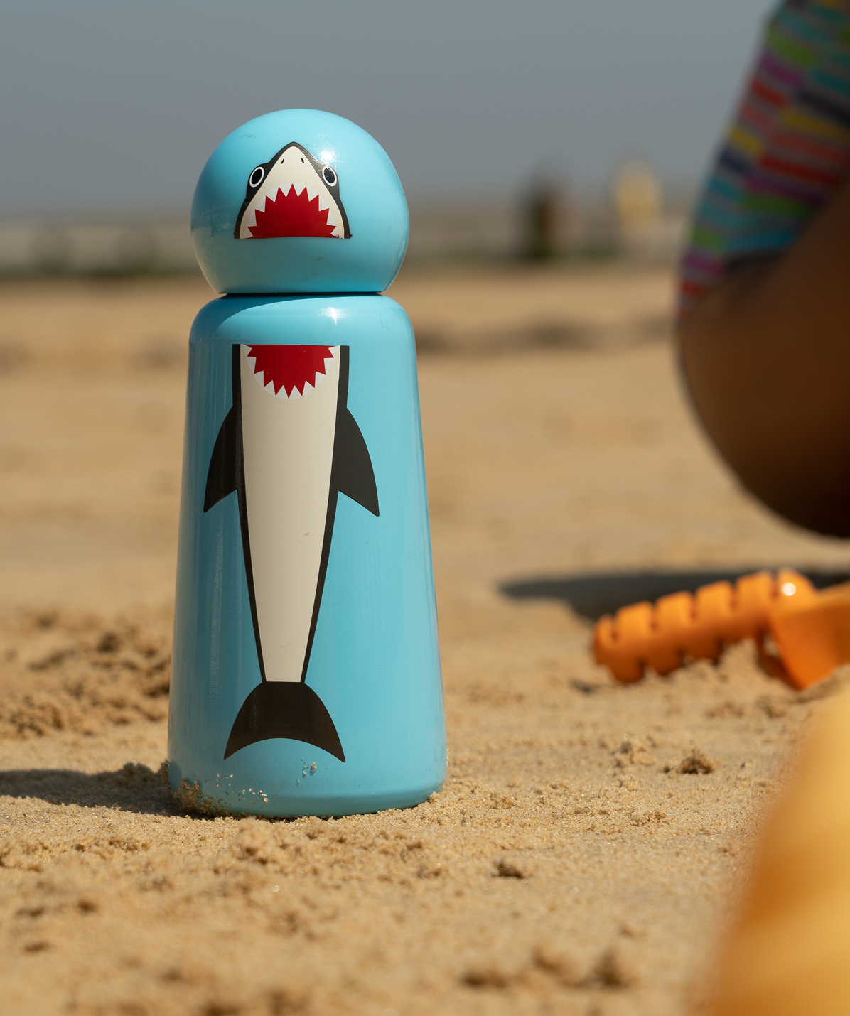 Botella Lund Shark, tiburón 300ml. Sujeta por persona al aire libre. Accesorio elegante y liviano para el día a día.