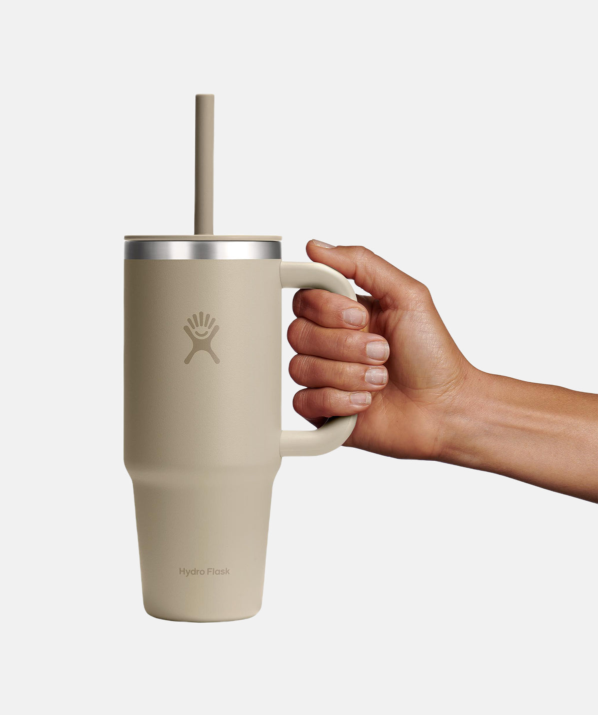 Vista lateral del Termo de viaje Hydro Flask Travel Tumbler Oat 24oz con asa y pajita.