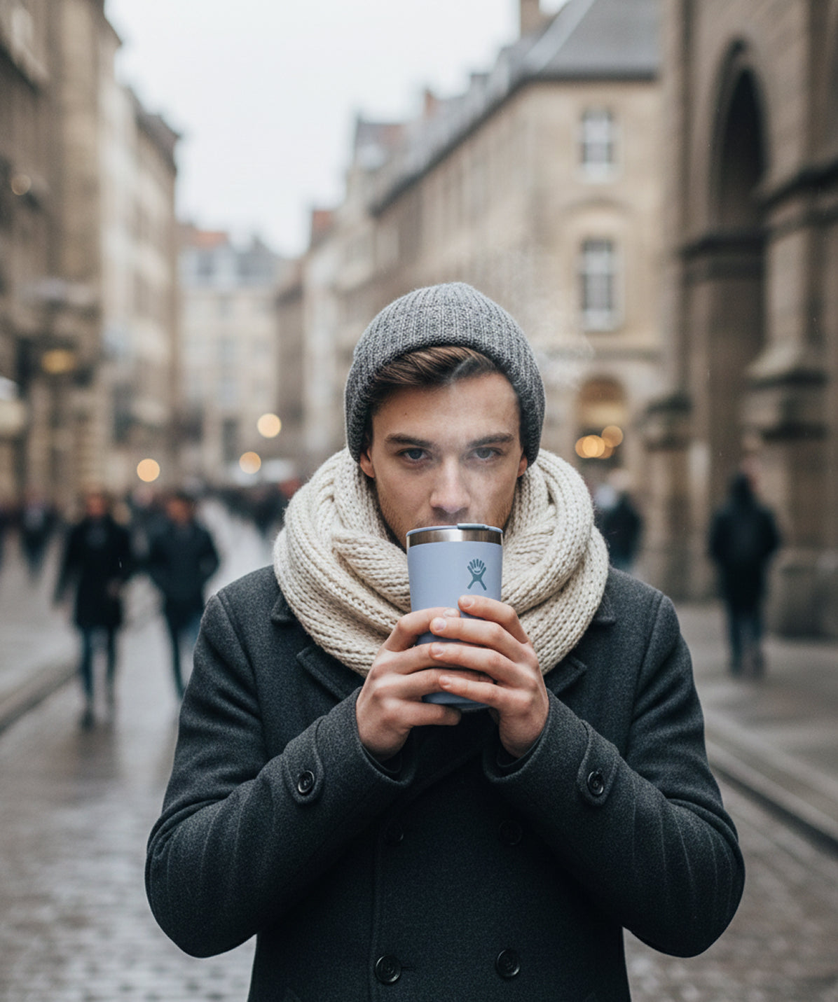 Hombre bebiendo de un Vaso Térmico Hydro Flask Surf 12oz en la ciudad. Vaso de acero inoxidable para bebidas calientes.